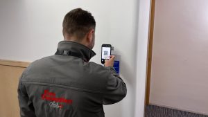 Fire Prevention operative scanning QR Code for Waking Watch