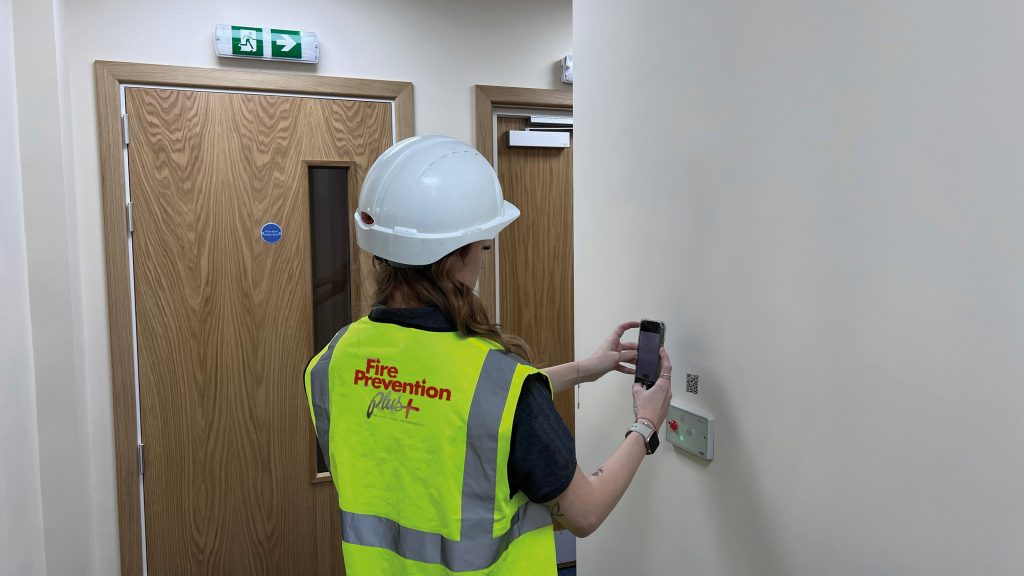 Female operative scanning QR Code for Waking Watch